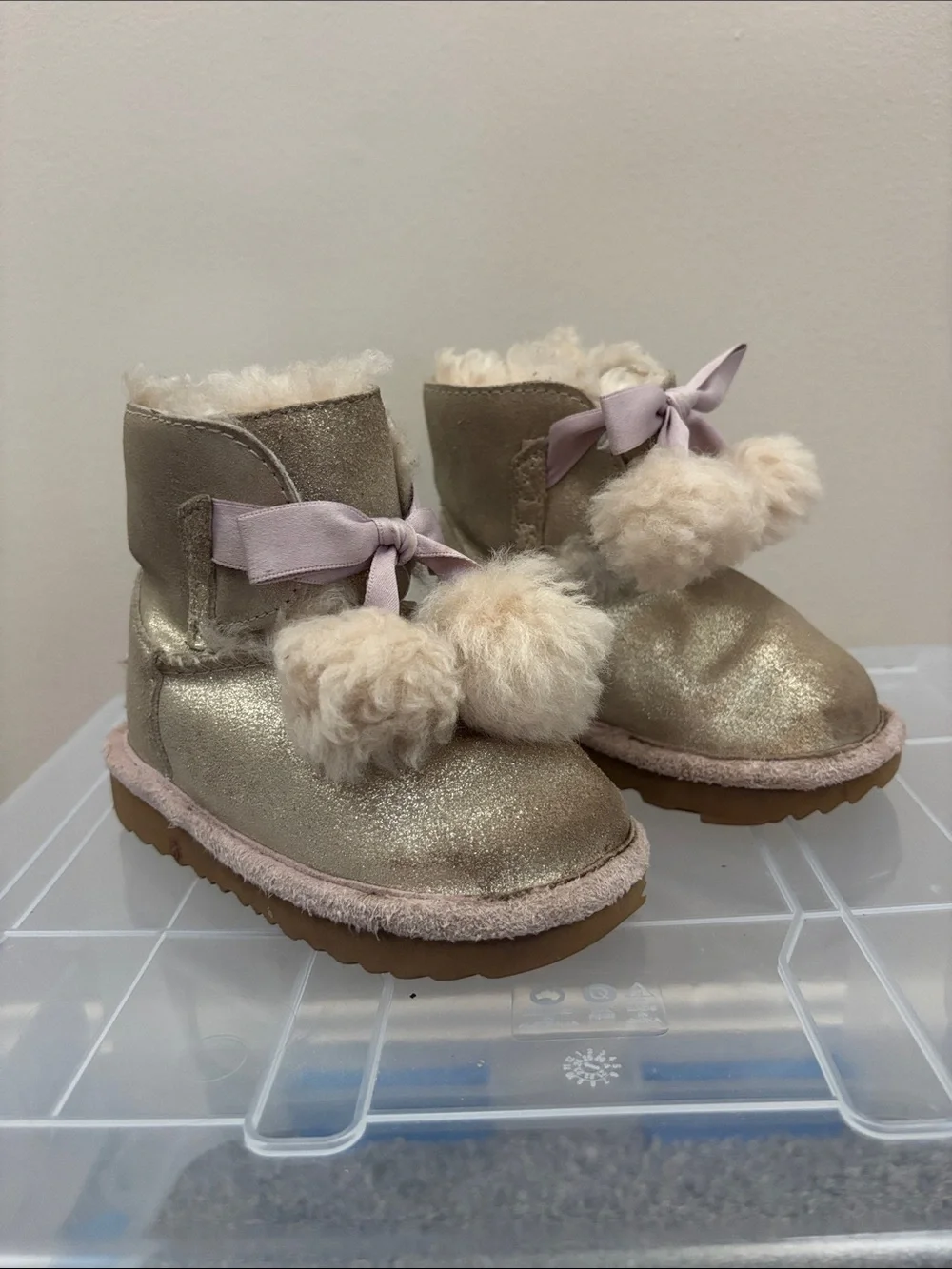 UGG Kids Metallic Gold Pom-Pom Boots with Pink Ribbon